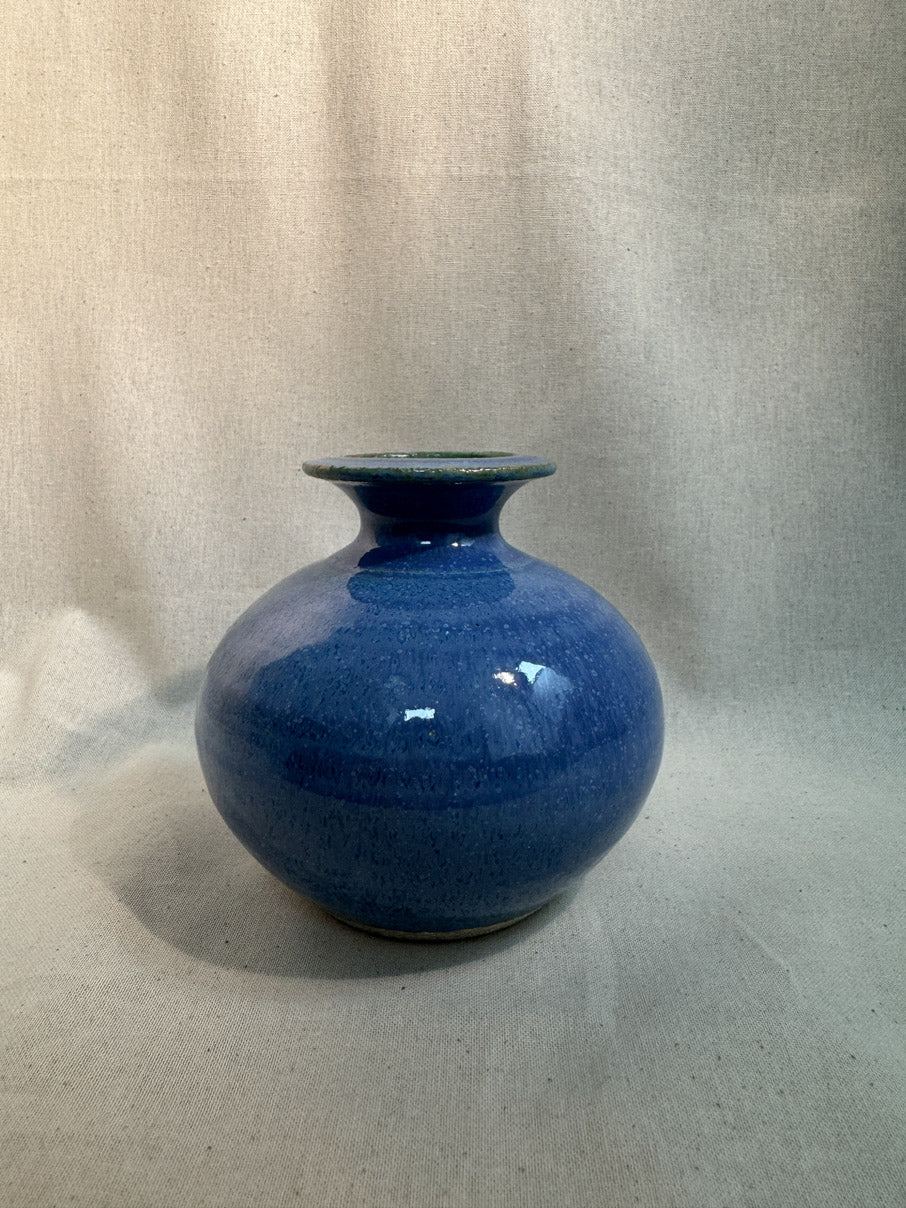 Blue glazed ceramic vase with green accents