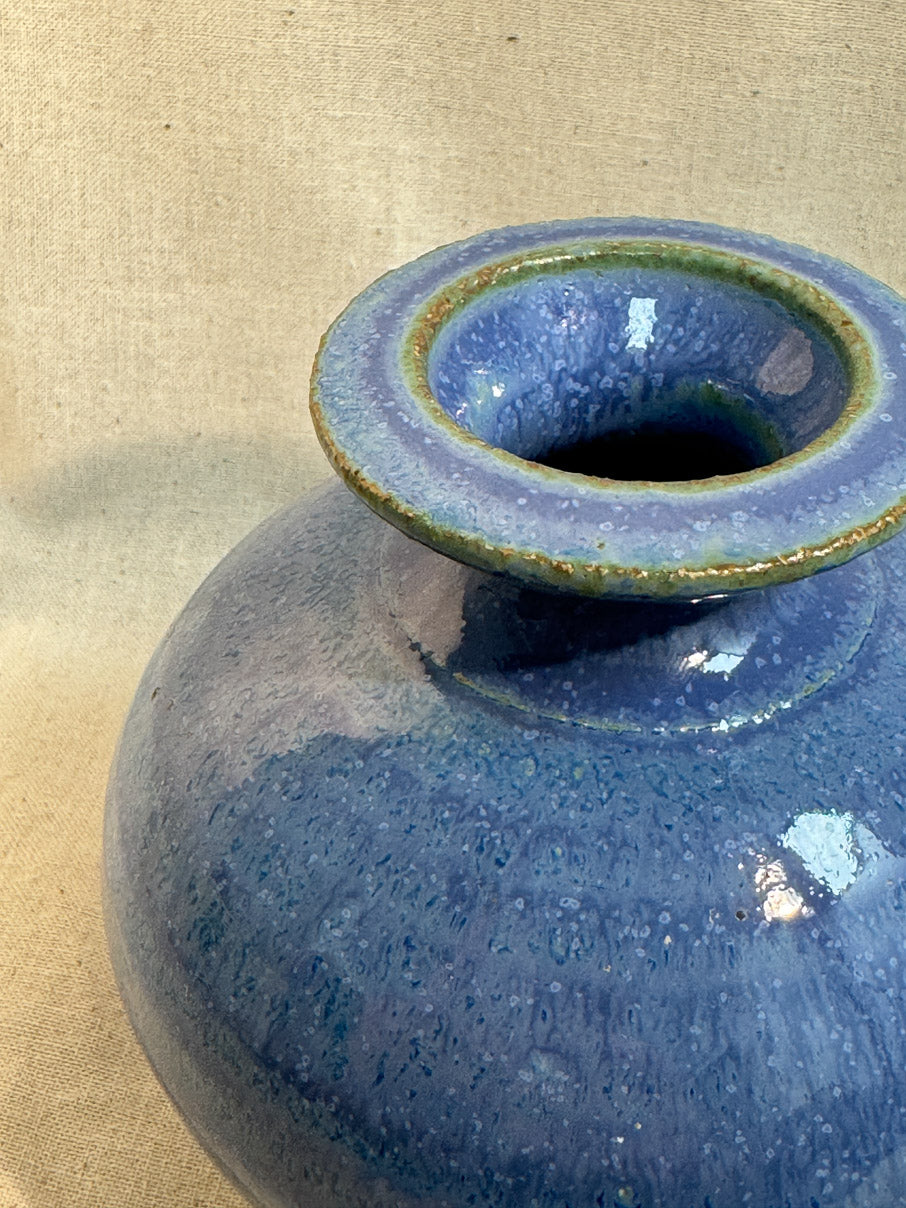 Blue glazed ceramic vase with green accents