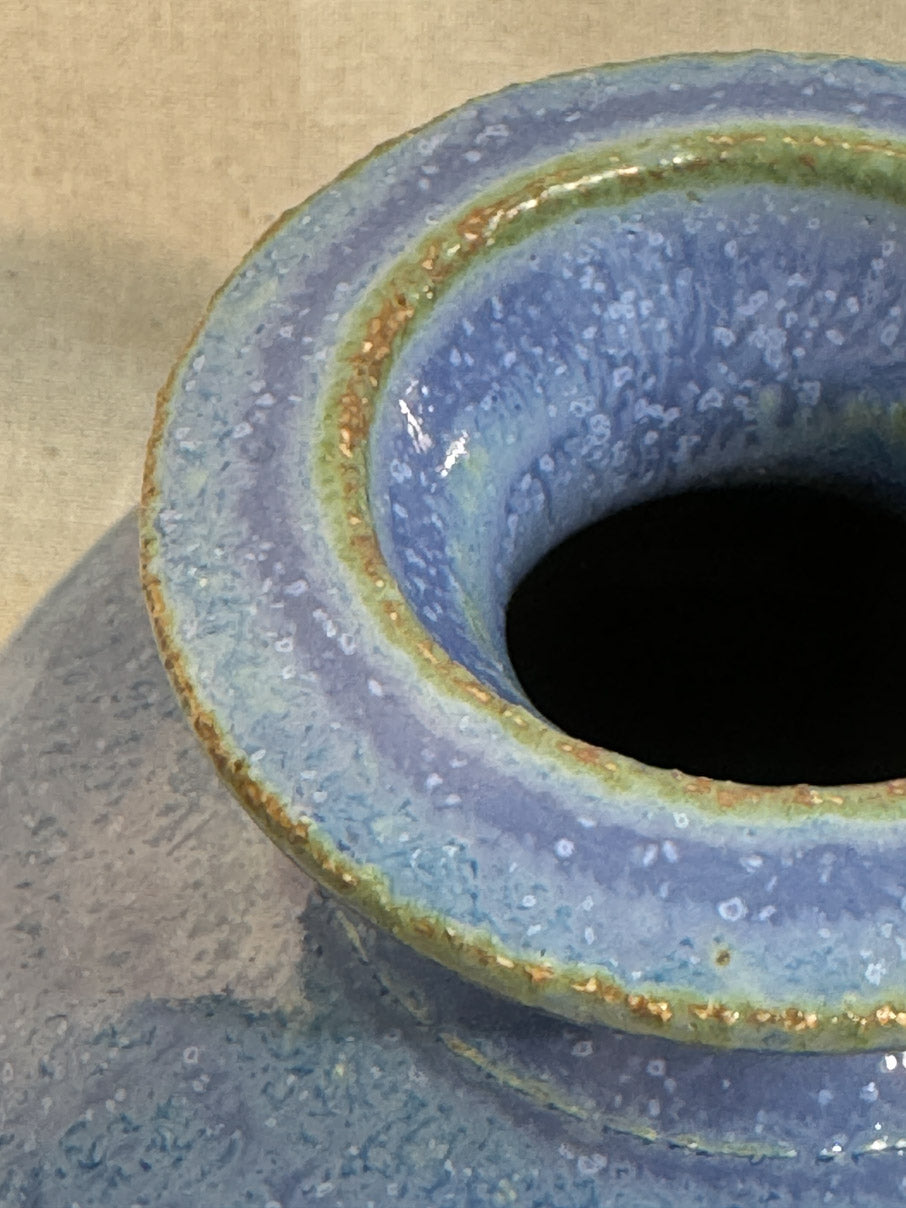 Blue glazed ceramic vase with green accents